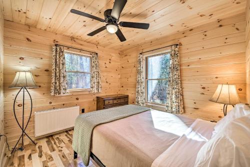 a bedroom with a bed and a ceiling fan at Inviting Webb Lake Cabin with Mountain Views in Weld