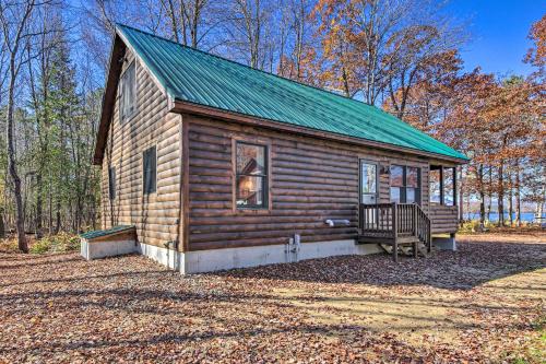 a small log cabin with a green roof at Inviting Webb Lake Cabin with Mountain Views in Weld
