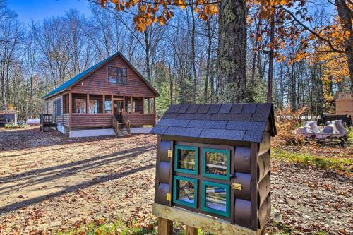 a small cabin in the middle of a forest at Inviting Webb Lake Cabin with Mountain Views in Weld