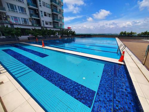 a large swimming pool in front of a building at Seaview Homestay Masai by Heyday in Masai