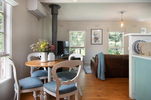a kitchen and living room with a table and chairs at Foxmere in Daylesford