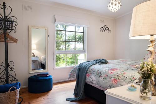 a bedroom with a bed and a window at Foxmere in Daylesford