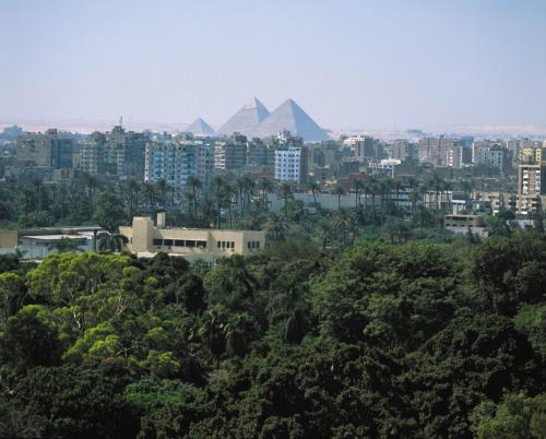 a view of the pyramids and buildings in the city at Four Seasons Cairo At The First Residence in Cairo