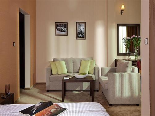 a living room with a couch and a chair at Hotel Villa Kaylaka in Pleven