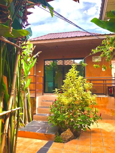 a house with stairs and plants in front of it at Panisara Pool Villa Resort Huahin in Hua Hin