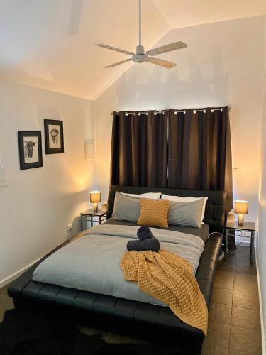 a bedroom with a bed with a black headboard at Elevation652 at Mt Bellevue in King Valley in Myrrhee