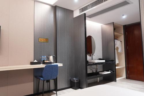 a bathroom with a counter and a blue chair at Joy Hotel in Phnom Penh