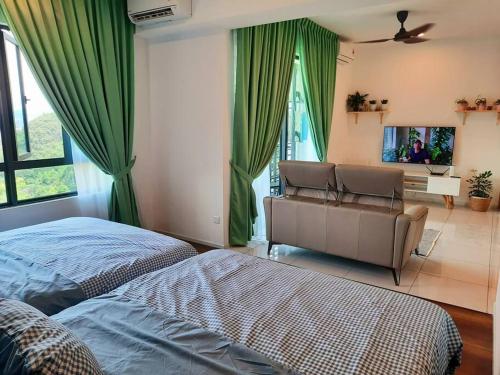 a bedroom with two beds and a couch and green curtains at Sunway Onsen Studio @ Lost World of Tambun in Ipoh