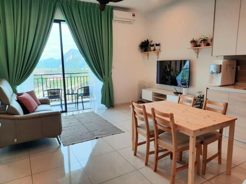 a living room with a table and chairs and a television at Sunway Onsen Studio @ Lost World of Tambun in Ipoh