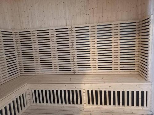 a wooden bench in a room with wooden shutters at Sunway Onsen Studio @ Lost World of Tambun in Ipoh