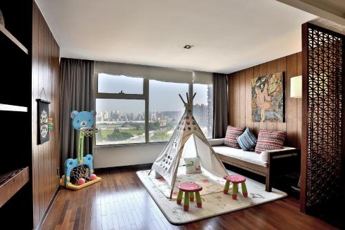 a living room with a play tent and a couch at SSAW Boutique Hotel Hangzhou Wildwind in Hangzhou