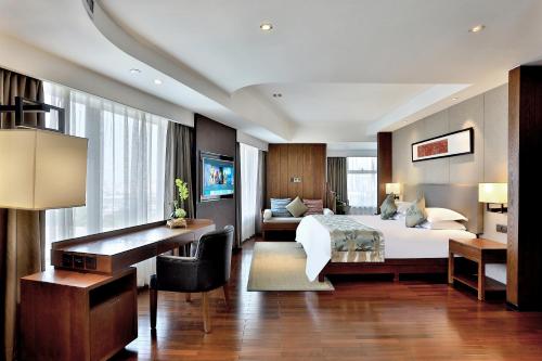 a hotel room with a bed and a desk at SSAW Boutique Hotel Hangzhou Wildwind in Hangzhou