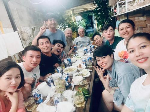 a group of people sitting around a long table at Uyen's House in Con Dao