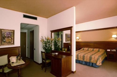 Postel nebo postele na pokoji v ubytování Balletti Park Hotel
