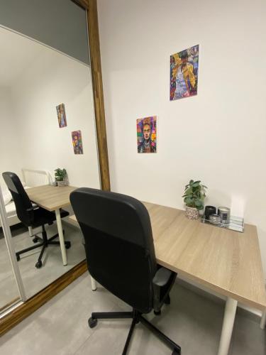 a conference room with two desks and a mirror at אמור in Beer Sheva