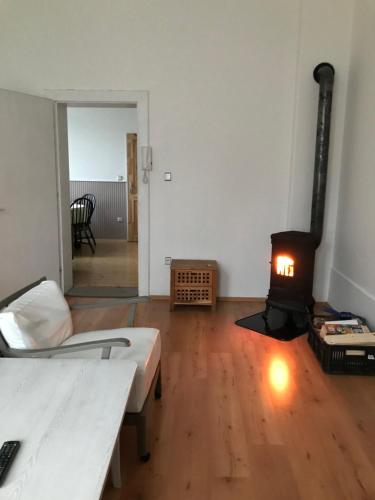 a room with a bed and a wood stove at Apartmán U Borovice in Rychnov nad Kněžnou