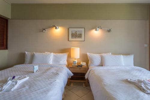 Postel nebo postele na pokoji v ubytování Palau Royal Resort