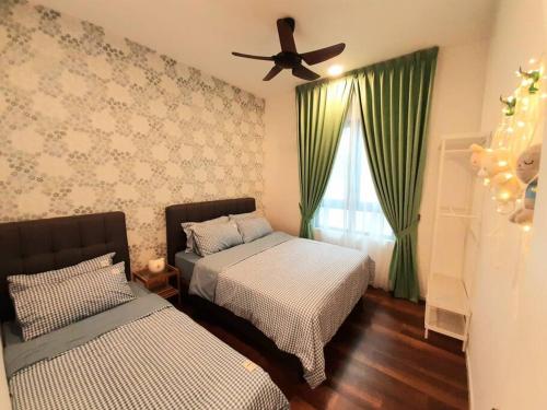 a bedroom with two beds and a ceiling fan at Sunway Onsen Theme Park View @Lost World of Tambun in Ipoh