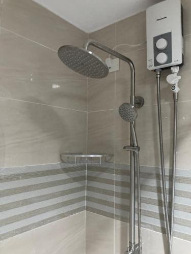 a shower with two lights in a bathroom at 1523 MIGAs Haven at Sunvida across SM City in Cebu City