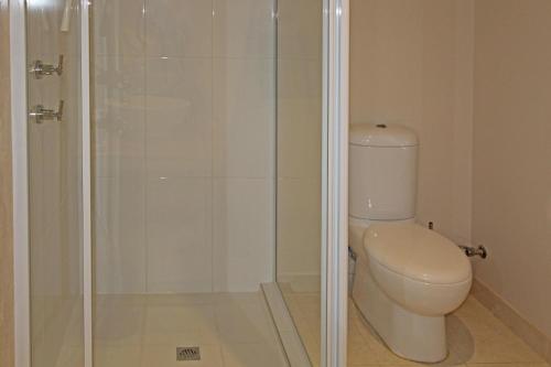 a bathroom with a toilet and a glass shower at Ocean Breeze in Jurien Bay