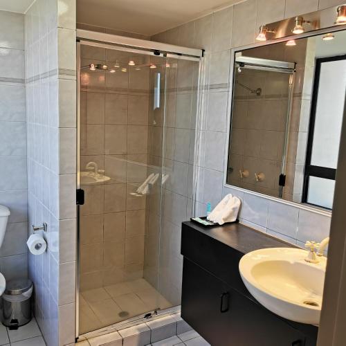 a bathroom with a shower and a sink at Penthouse in Surfers Hawaiian Holiday Apartments in Gold Coast