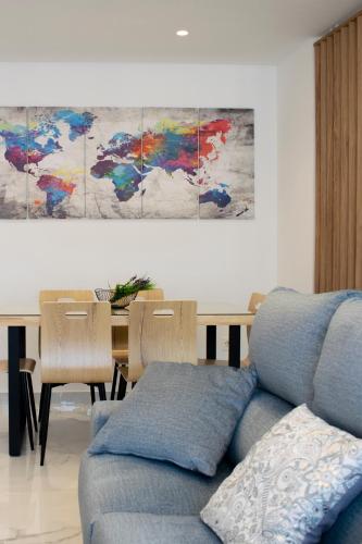 a living room with a blue couch and a table at Deluxe Apartament Alcalá la Real in Alcalá la Real