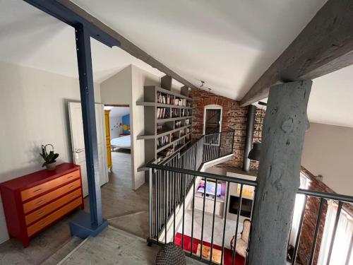 a room with a staircase with a book shelf at Magnifique maison toulousaine in Toulouse