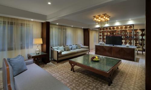 a living room with a couch and a table at InterContinental Bahrain by IHG in Manama