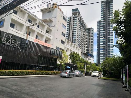 a street with cars parked on the side of a building at The Base Central Pattaya Thai in Pattaya