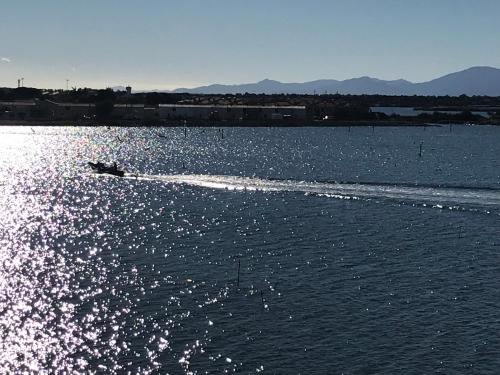 a boat on a body of water at Ile du Cap Couladère - Vue magnifique lac marin - Baignoire Jaccuzi - Complexe piscine, sportif, animations in Le Barcarès
