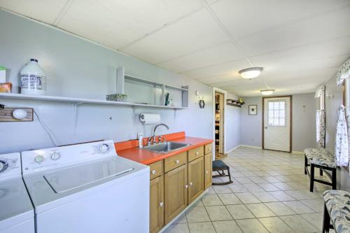 a kitchen with a washing machine and a sink at Scenic Gosport Getaway, Over 100 Years Old 
