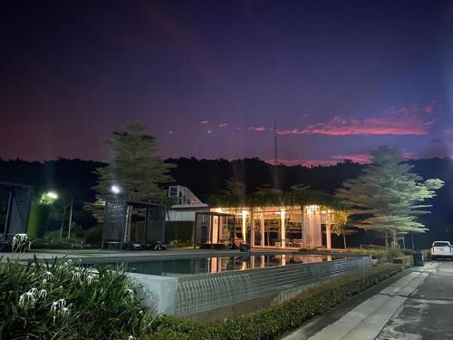 a building with a swimming pool at night at The Midst by The M - Nakhon Nayok TMD4 in Ban Som Phung Haeng (1)