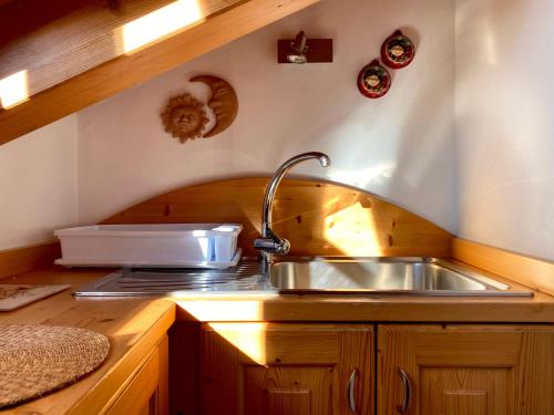 a kitchen with a sink and a counter top at Monolocale in chalet alpino 022143-AT-010681 in Madonna di Campiglio