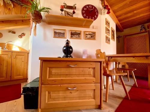 a kitchen with a wooden cabinet and a table at Monolocale in chalet alpino 022143-AT-010681 in Madonna di Campiglio