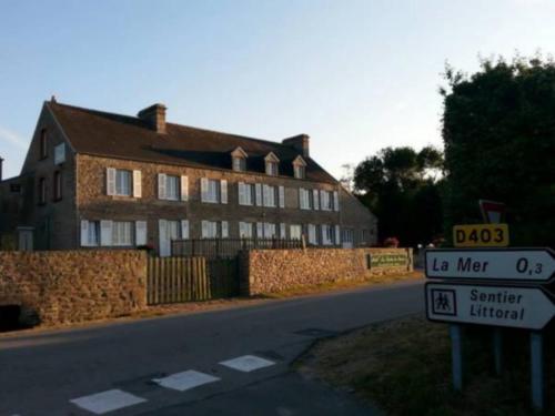 a street sign in front of a large house at La Roche du Marais in Omonville-la-Petite
