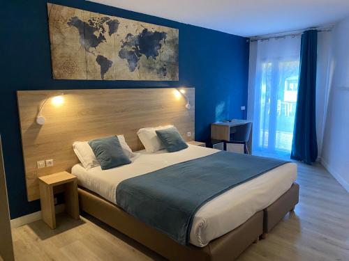 a bedroom with a large bed with a map on the wall at Le Floréal in Vence