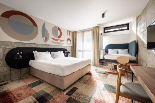 a hotel room with two beds and a desk at Forest Hotel in Kraków