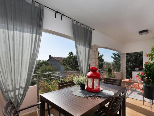 a dining room table with a red lantern on a balcony at Luxury Apartment Vabriga in Vabriga