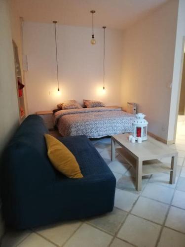 un salon avec un canapé et un lit dans l'établissement Gîte largentiere, à Largentière