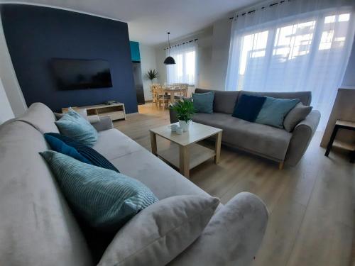 a living room with a couch and a table at Chabrowa Apartamenty 1 in Milicz