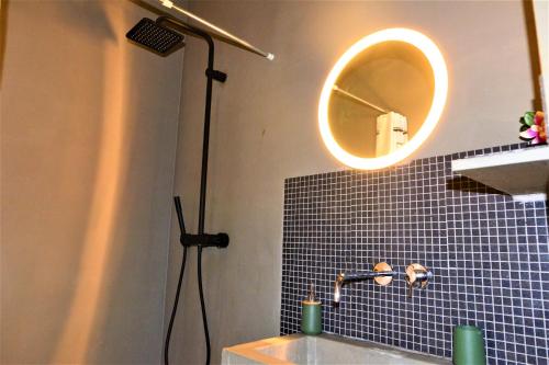 a bathroom with a shower and a sink and a mirror at SLEEP INN - Industrial Flat Citycenter in Antwerp