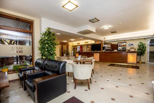 a lobby of a hotel with tables and chairs at Hotel Boss in Žilina
