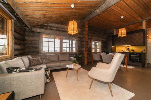 a living room with a couch and a table at Villa Huippu in Syöte