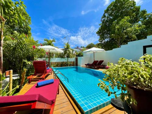 a swimming pool with two lawn chairs and a swimming poolvisor at Shark lounge in Fuvahmulah