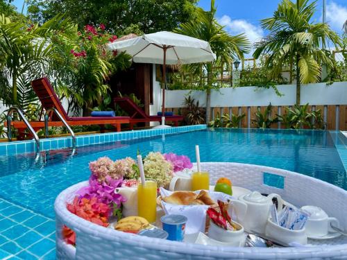 a tray of breakfast food next to a swimming pool at Shark lounge in Fuvahmulah