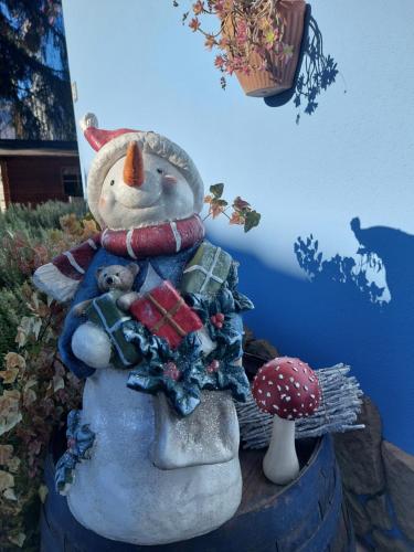 a statue of a snowman holding a teddy bear at BnB Trento in Trento