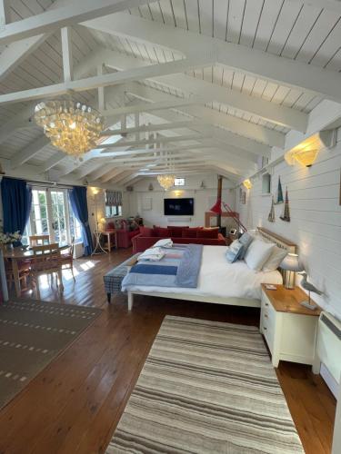 a bedroom with a large bed and a living room at Sailaway perfect romantic break in Norwich