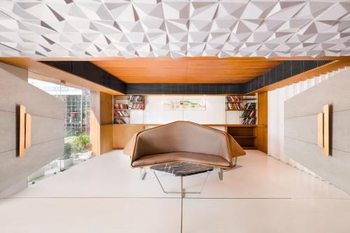 a living room with a couch and a table at Keys Select by Lemon Tree Hotels, Gandhi Ashram, Ahmedabad in Ahmedabad