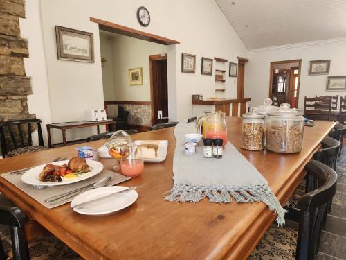 a wooden table with a plate of food on it at St Aidan's Manor in Grahamstown