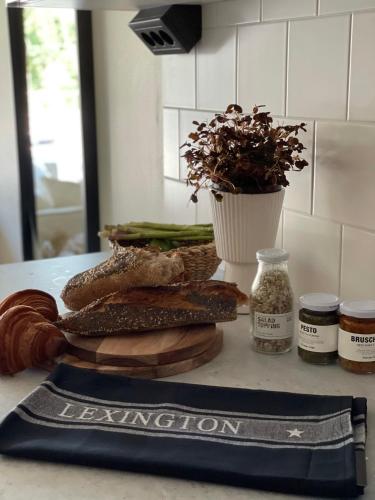 a counter with bread and other foods on a table at Hotell Hanöhus Hällevik in Sölvesborg